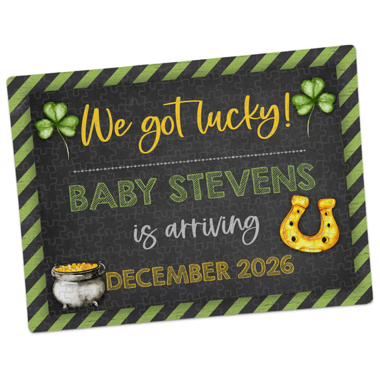 St. Patrick’s Day pregnancy announcement puzzle with chalkboard-style design, green striped border, shamrocks, horseshoe, and pot of gold, reading “We got lucky! Baby Stevens is arriving December 2026”