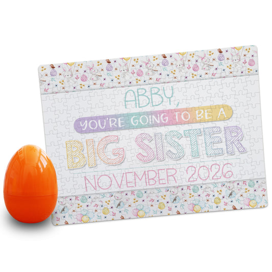Personalized big sister pregnancy announcement puzzle reading “Abby, you’re going to be a big sister, November 2026” with Easter bunny pattern border and orange egg prop
