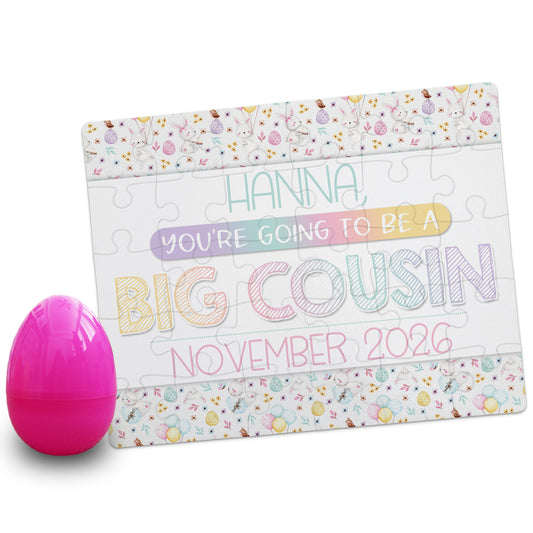 Personalized big cousin pregnancy announcement puzzle reading “Hanna, you’re going to be a big cousin, November 2026” with pastel Easter design and pink egg prop