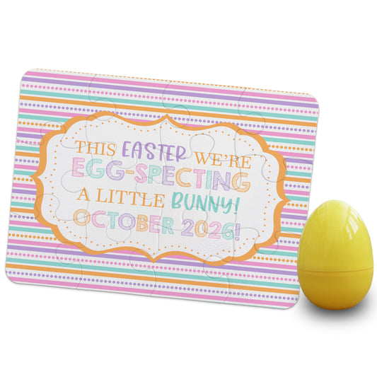 Easter pregnancy announcement puzzle reading “This Easter we’re egg-specting a little bunny, October 2026” with colorful striped background and yellow egg prop
