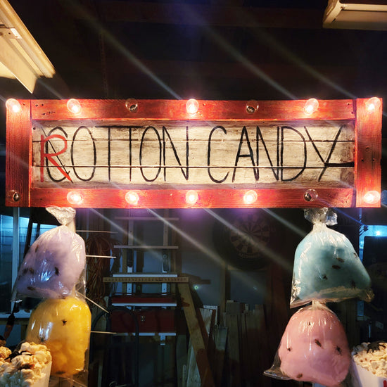 A wooden sign with lights reads 