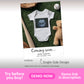 A baby onesie with an ultrasound image printed on it is displayed on artificial grass next to a teddy bear, baseball bat, glove, and ball. Text reads, "Coming soon... Baby Baker Due January 2026.