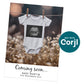 A baby onesie with an ultrasound image hangs on a clothesline in a field. Text below reads: "Coming soon... BABY MARTIN DUE NOVEMBER 2025.