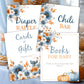 Baby shower table setup with printable floral signs including diaper raffle, books for baby, and cards and gifts signage